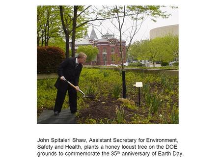 John Spitaleri Shaw, Assistant Secretary for Environment, Safety and Health, plants a honey locust tree on the DOE grounds to commemorate the 35th anniversary.