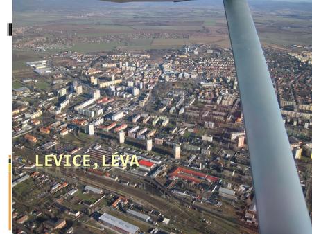  The town lies on the left bank of the Hron River.  It is the main town of the Levice District, which is the largest district in Slovakia.  The town's.