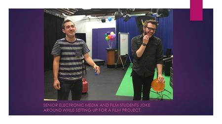 SENIOR ELECTRONIC MEDIA AND FILM STUDENTS JOKE AROUND WHILE SETTING UP FOR A FILM PROJECT.