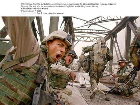 U.S. Marines from the 3rd Batallion urge infantrymen to rush across the damaged Baghdad Highway bridge on Monday. The unit is in the southeastern outskirts.